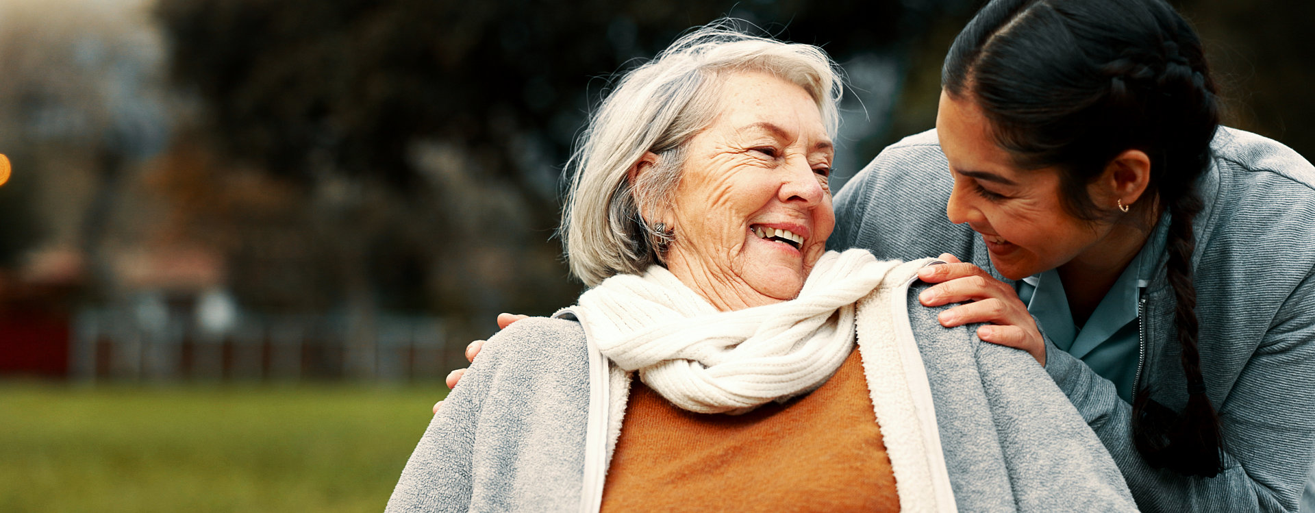 A woman and an elderly woman smiling