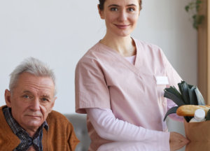 A man and a nurse with a bag of grocery beside