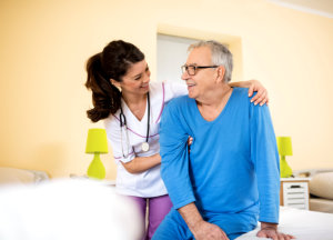 A nurse and an old man smiling