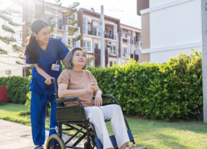 A nurse looking at the elderly woman
