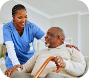 A nurse and an elderly man smiling