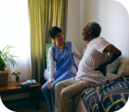 A nurse talking to an elderly man
