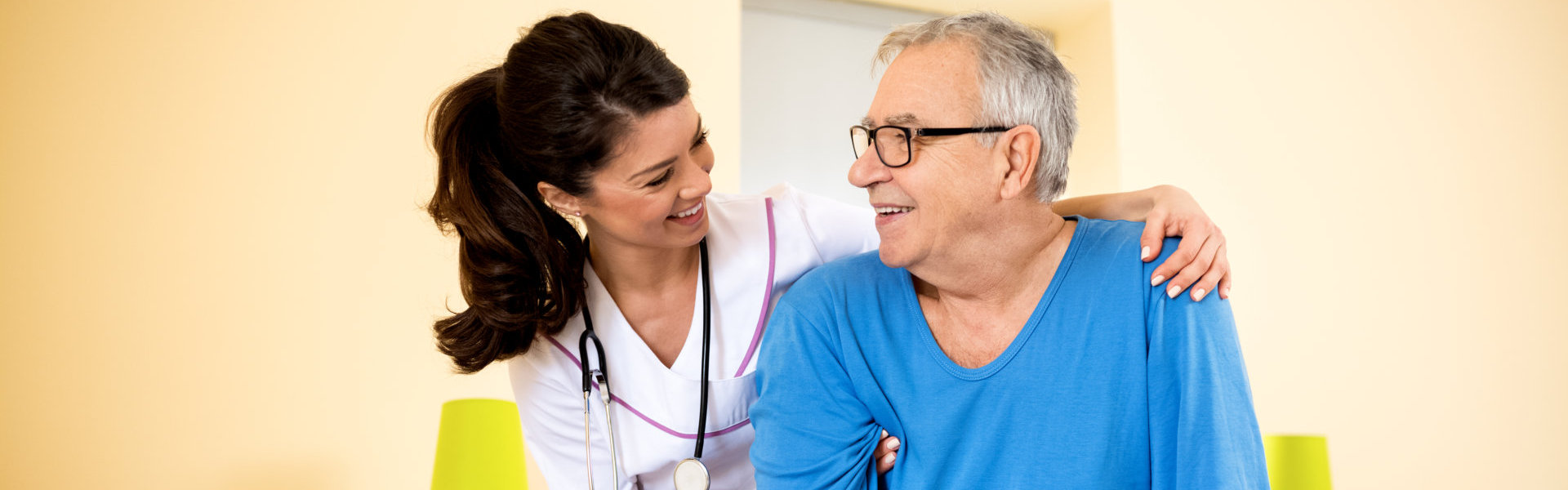 A nurse and an old man smiling