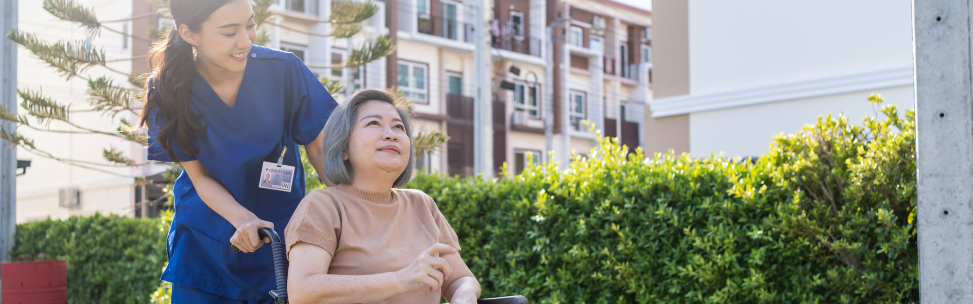 A nurse looking at the elderly woman