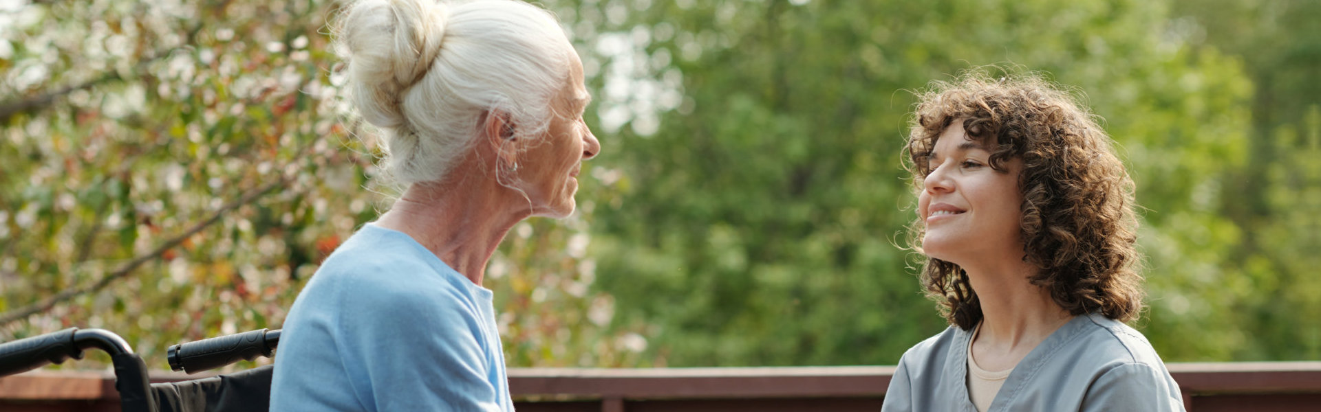 A woman talking to an elderly woman